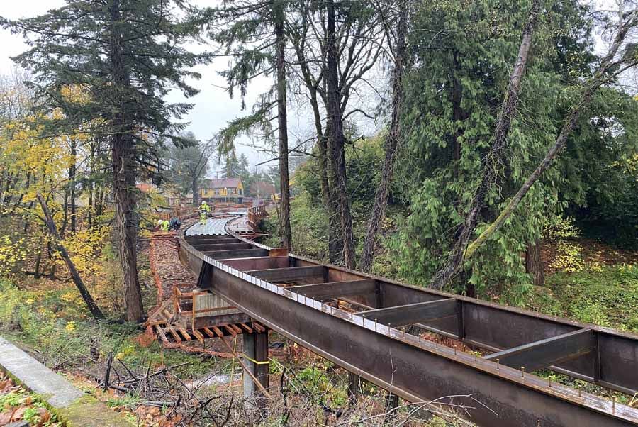 Red Electric Curved Steel Trail Bridge Provides Pedestrians and Cyclists a Car-Free Scenic Route into SW Portland